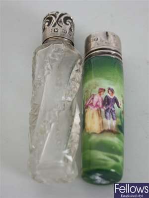 A cylindrical clear glass scent bottle with