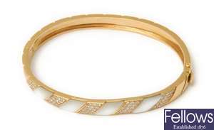 A mother of pearl and diamond hinged bangle, with