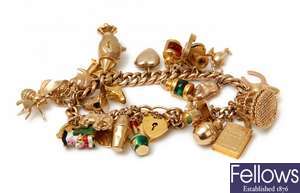 A 9ct gold curb link charm bracelet with thirty