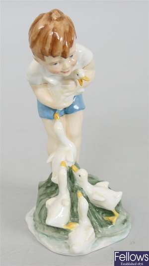 A Royal Worcester figure of a boy holding ducks,