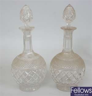 A pair of cut glass bottle shaped decanters with