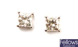 A pair of princess cut diamond ear studs - each