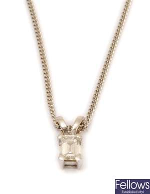 An 18ct white gold single stone trap cut diamond