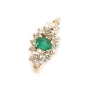 An emerald and diamond cluster ring, comprising a