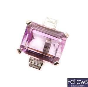 A Kunzite and diamond ring with a central trap