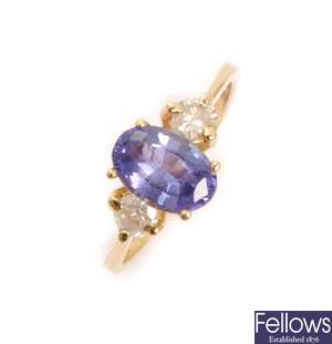 A three stone tanzanite and diamond ring, with a