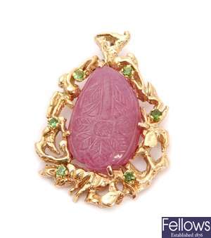 A 9ct gold pendant with a central carved panel of