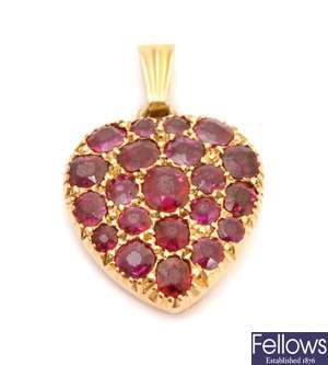 A heart shaped ruby pendant with pave set rubies
