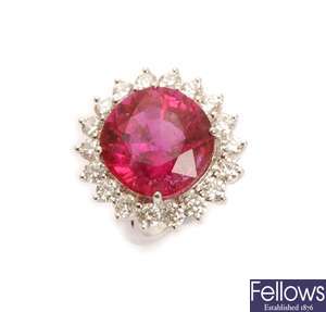 A rubelite and diamond cluster ring, comprising a