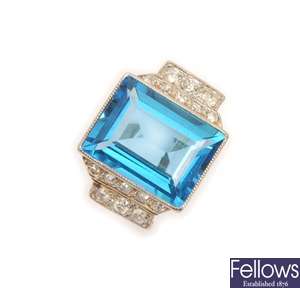 A blue topaz and diamond ring, with a central