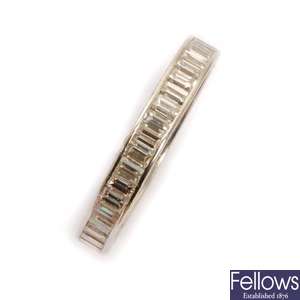 A baguette cut diamond full eternity ring, with