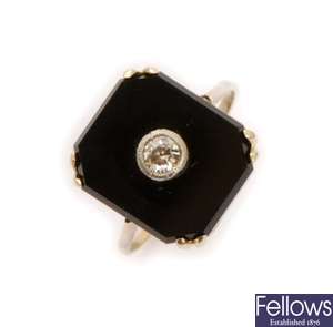 An onyx and diamond set ring, comprising a
