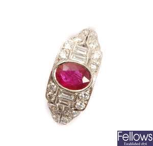 A ruby and diamond ring with a central oval ruby