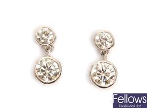 A pair of diamond set dropper earrings with a