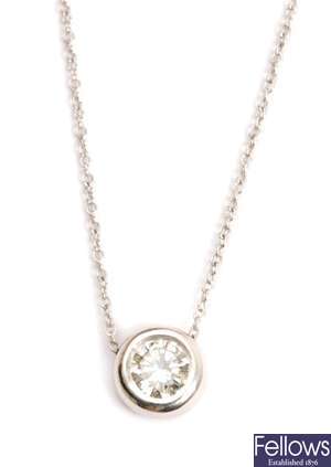 A diamond set pendant with a collet set round