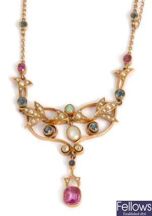 A multi gem set ornate necklet comprising a leaf