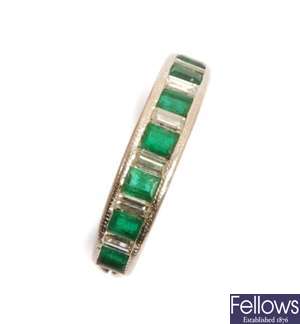 An emerald and diamond half eternity ring, with
