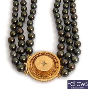 A three row black cultured pearl necklet,