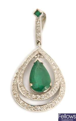 An emerald and diamond set pendant with a emerald