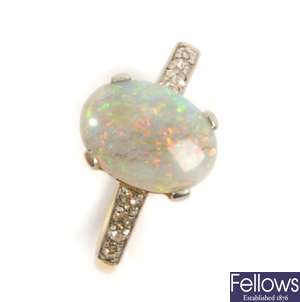 An opal and diamond ring, with a claw set oval