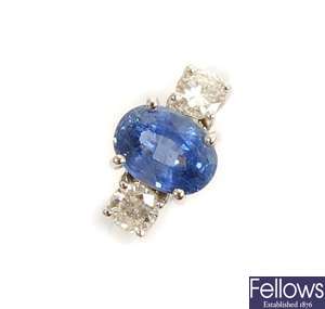 A three stone sapphire and diamond ring, with a