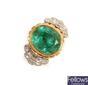 An emerald and diamond ring, comprising a central