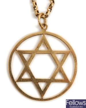 A 9ct gold circular star of David pendant with