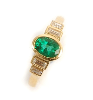 An 18ct gold emerald and diamond ring, comprising