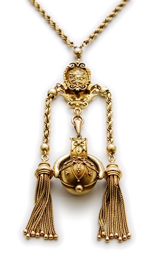 A Victorian ornate pendant, comprising a central