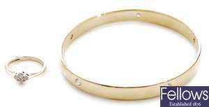 A 9ct gold bangle set with five inlaid round
