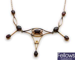 A garnet set necklace, comprising a central oval