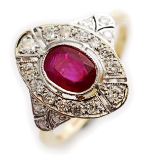 An oval ruby and diamond set cluster ring,