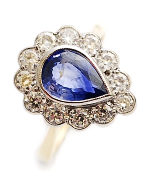 A pear shaped sapphire and diamond set cluster