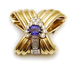 A tanzanite and diamond cluster pearl enhancer,