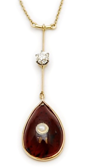 A garnet and diamond set pendant, comprising a
