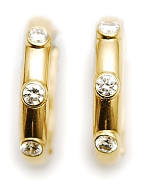 A pair of diamond set half hoop earrings, each