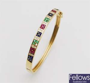 An 18ct gold hinged bangle with three sets of