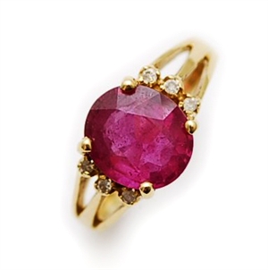 A ruby and diamond set ring, comprising an oval