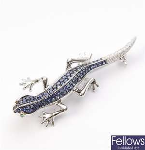 A sapphire and diamond set lizard brooch, with a