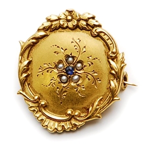 A French ornate floral design circular brooch,