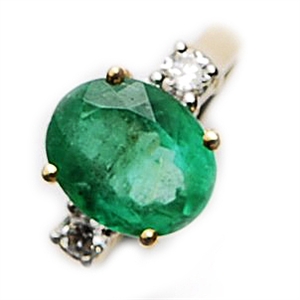 A three stone emerald and diamond set ring,