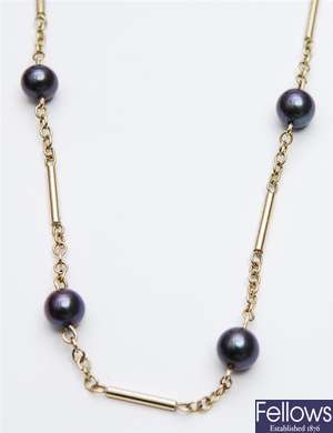 A 9ct gold black pearl set necklet, comprising