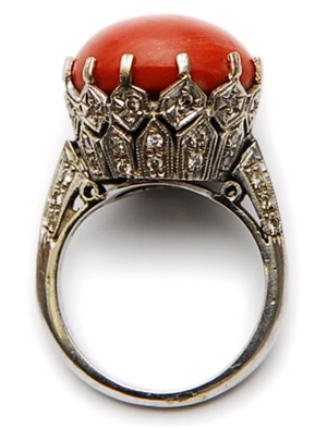 A coral and diamond set ring comprising a