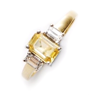 An 18ct gold three stone yellow sapphire and