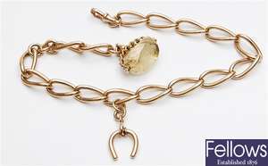 A 9ct gold stretched curb link albert chain with