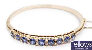 A sapphire and diamond set hinged bangle, with