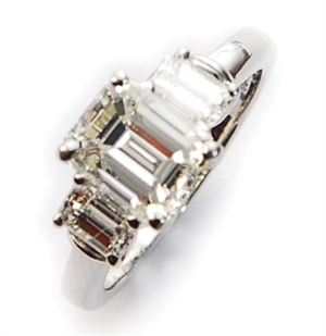 A platinum three stone diamond ring, comprising a