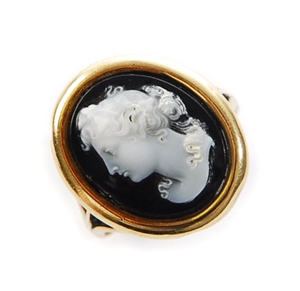 An oval hard stone cameo set ring, the central