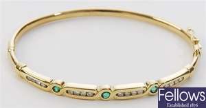 An emerald and diamond set hinged bangle,