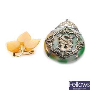 A large jade pendant overlaid with white metal in